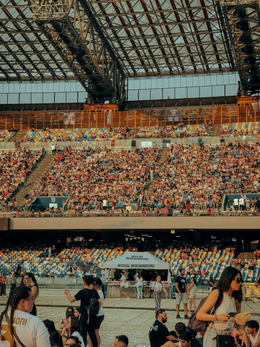 a large crowd of people sitting in a stadium