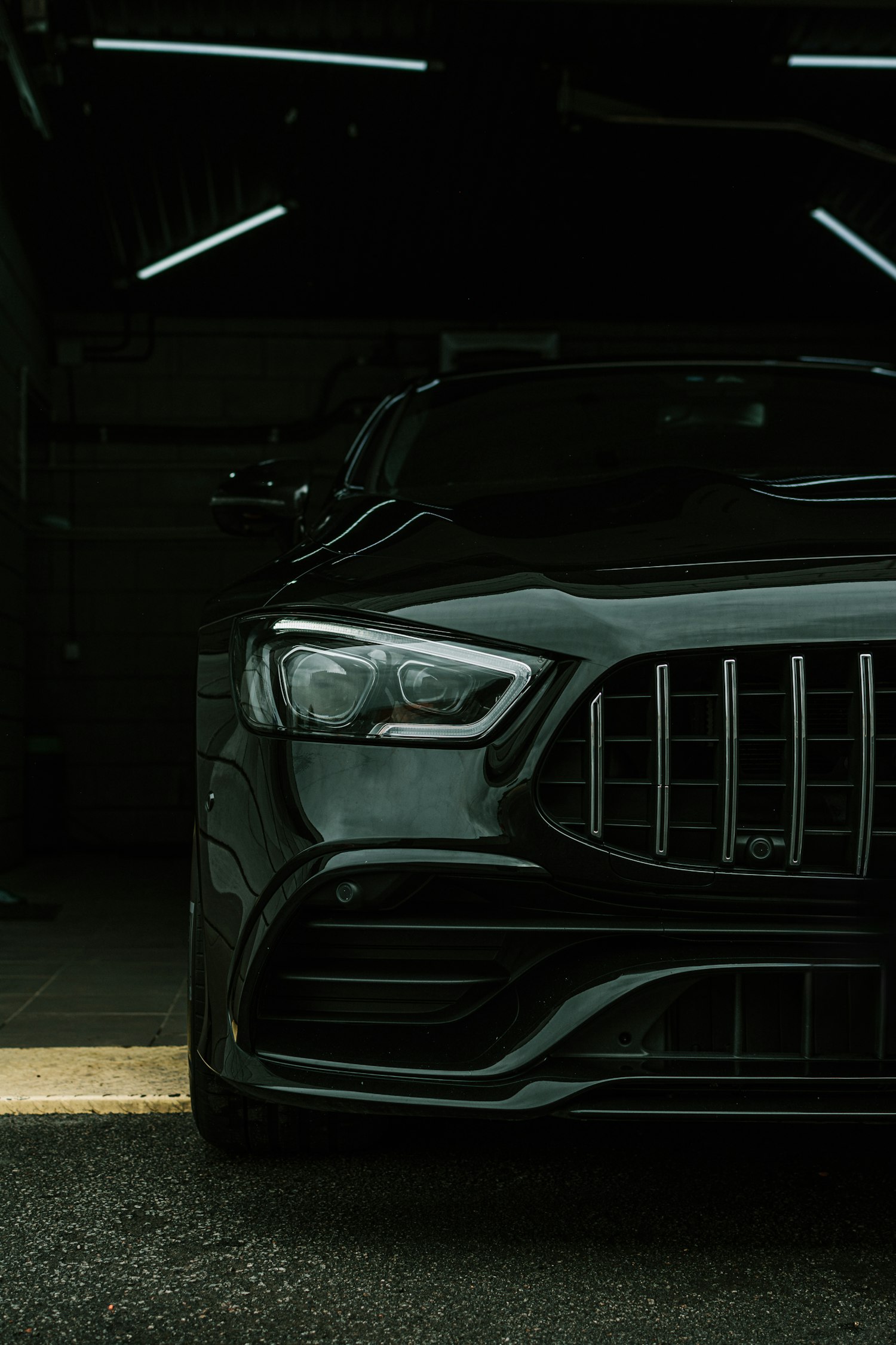 Dark sedan with tinted glass in a covered garage