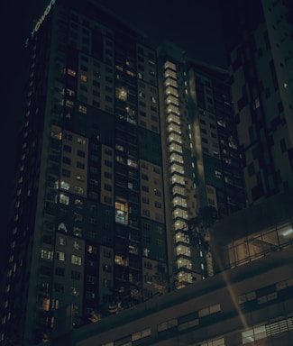 Night view of a high-end residential tower with illuminated balconies