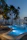 Luxurious hotel swimming pool at dusk with warm lighting and sleek modern design by Aquanusa