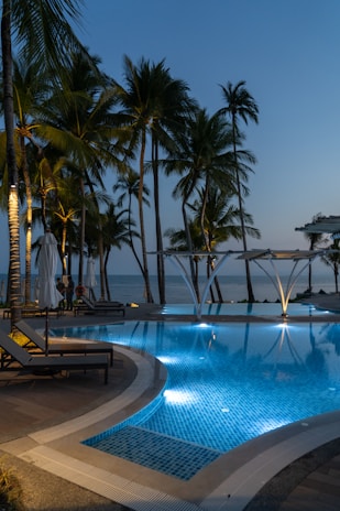 Evening view of a pool with soft underwater lighting creating a relaxing atmosphere.