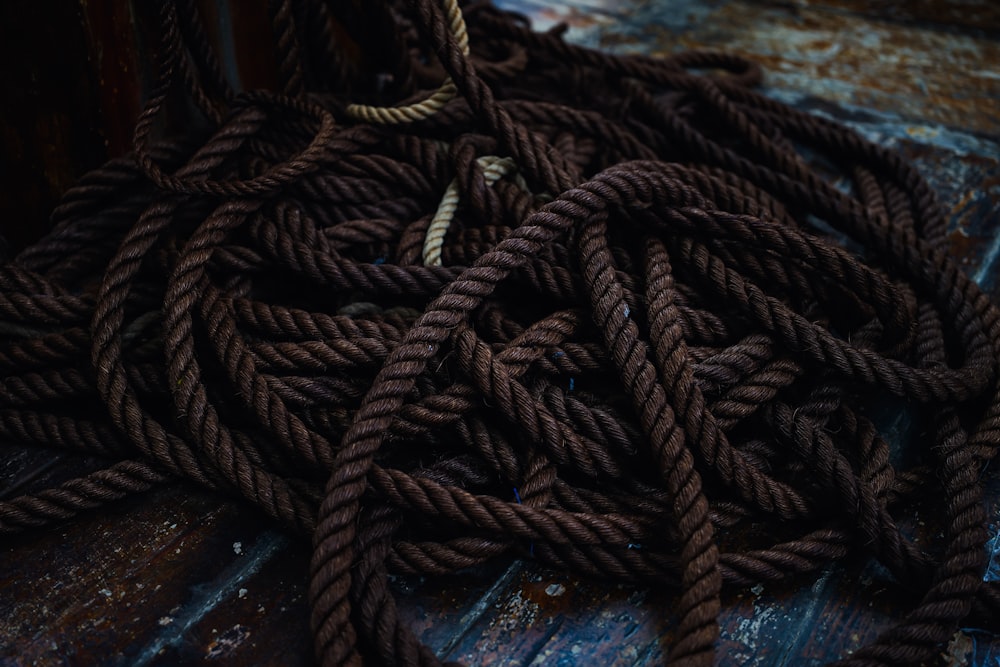 a pile of rope sitting on top of a wooden floor
