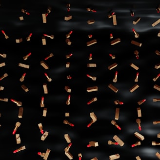 Close-up of vibrant MAC lipsticks arranged artistically against a sleek black and red animated background.