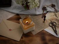 A cozy scene with scented candles flickering beside aesthetic stationery.