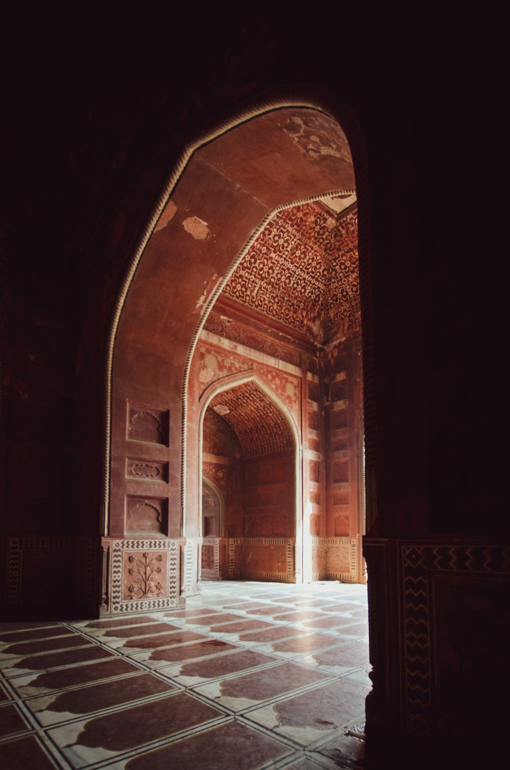 an archway in a building with a tiled floor