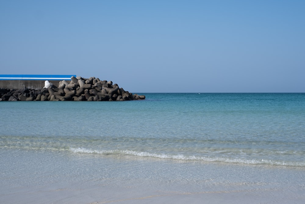 a blue and white building sitting on top of a beach