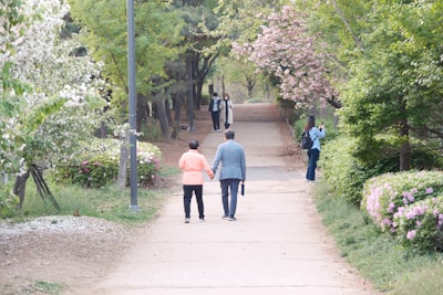 A couple enjoying a serene stroll through the blooming gardens surrounding the hotel.