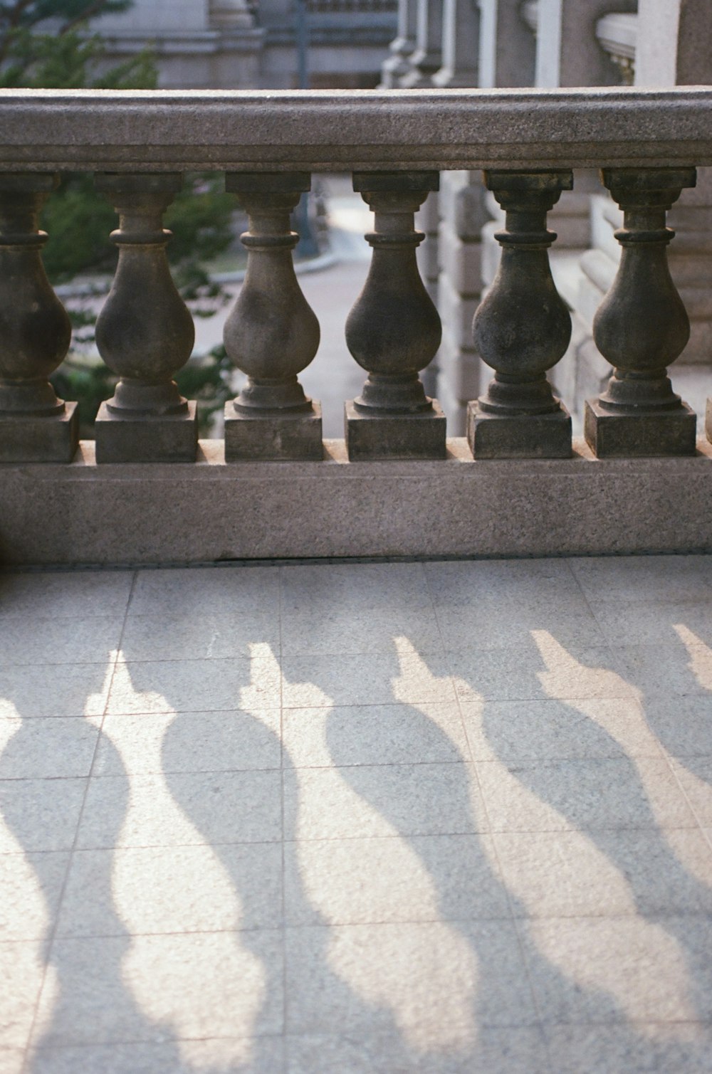 the shadow of a person walking down a sidewalk