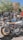 A group of satisfied customers posing with their motorcycles.
