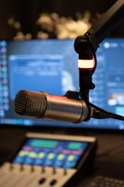 a microphone with a laptop in the background