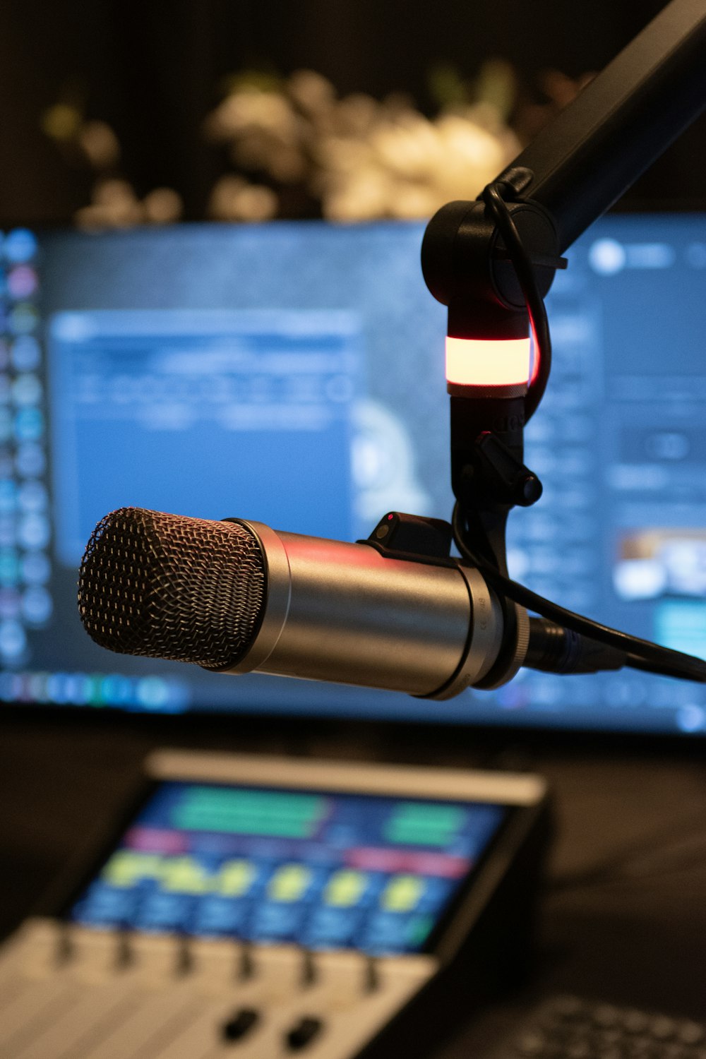 a microphone with a laptop in the background