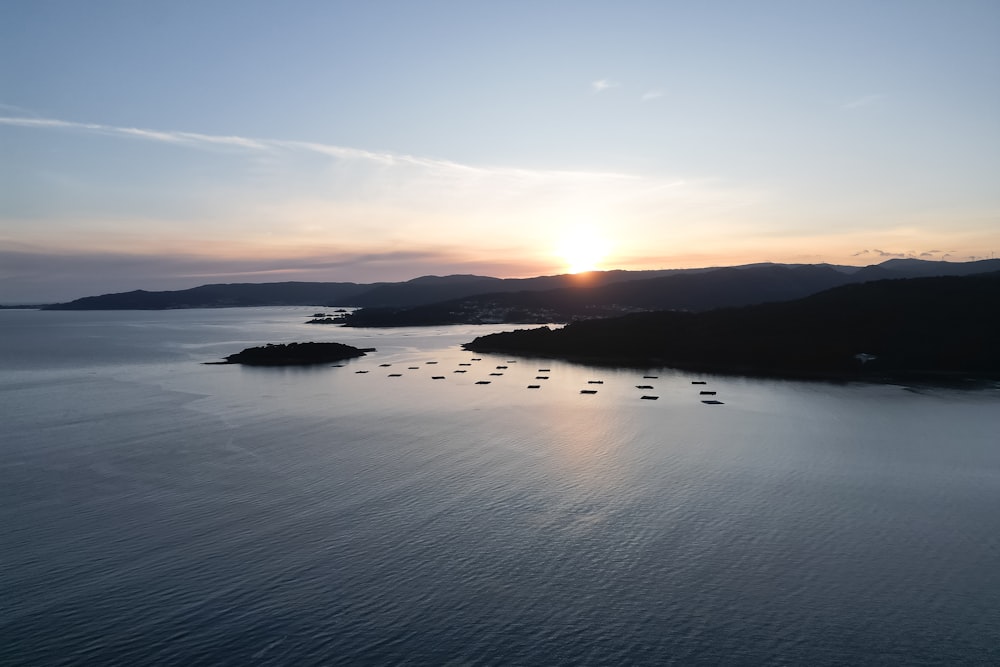 a group of boats floating on top of a large body of water