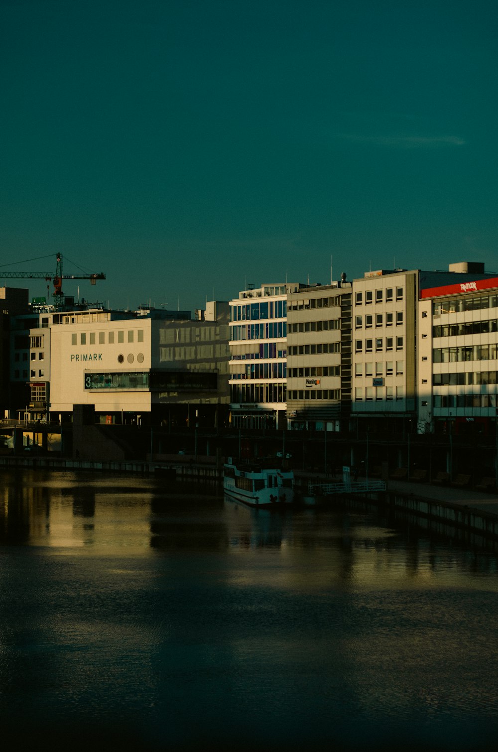 a body of water with buildings in the background