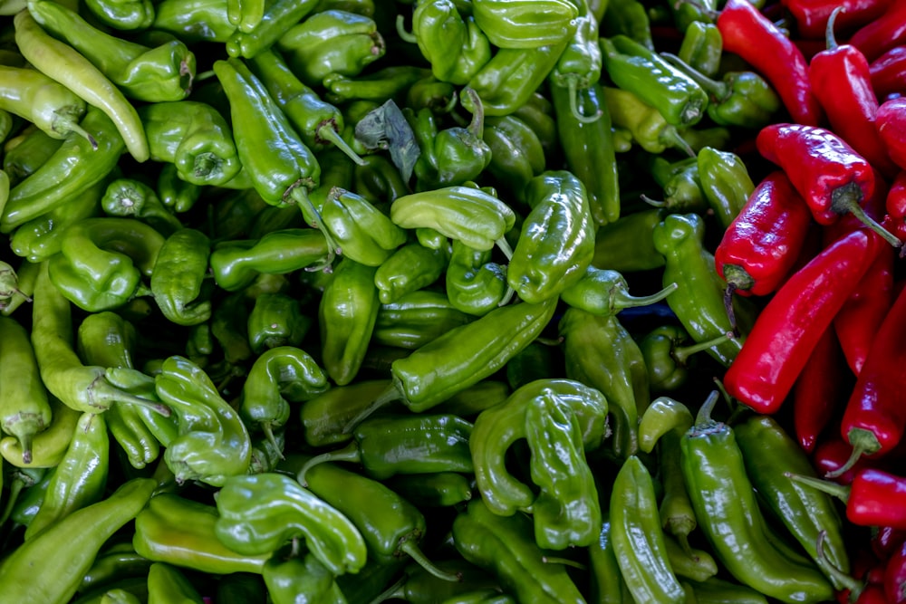 a pile of green peppers sitting next to each other