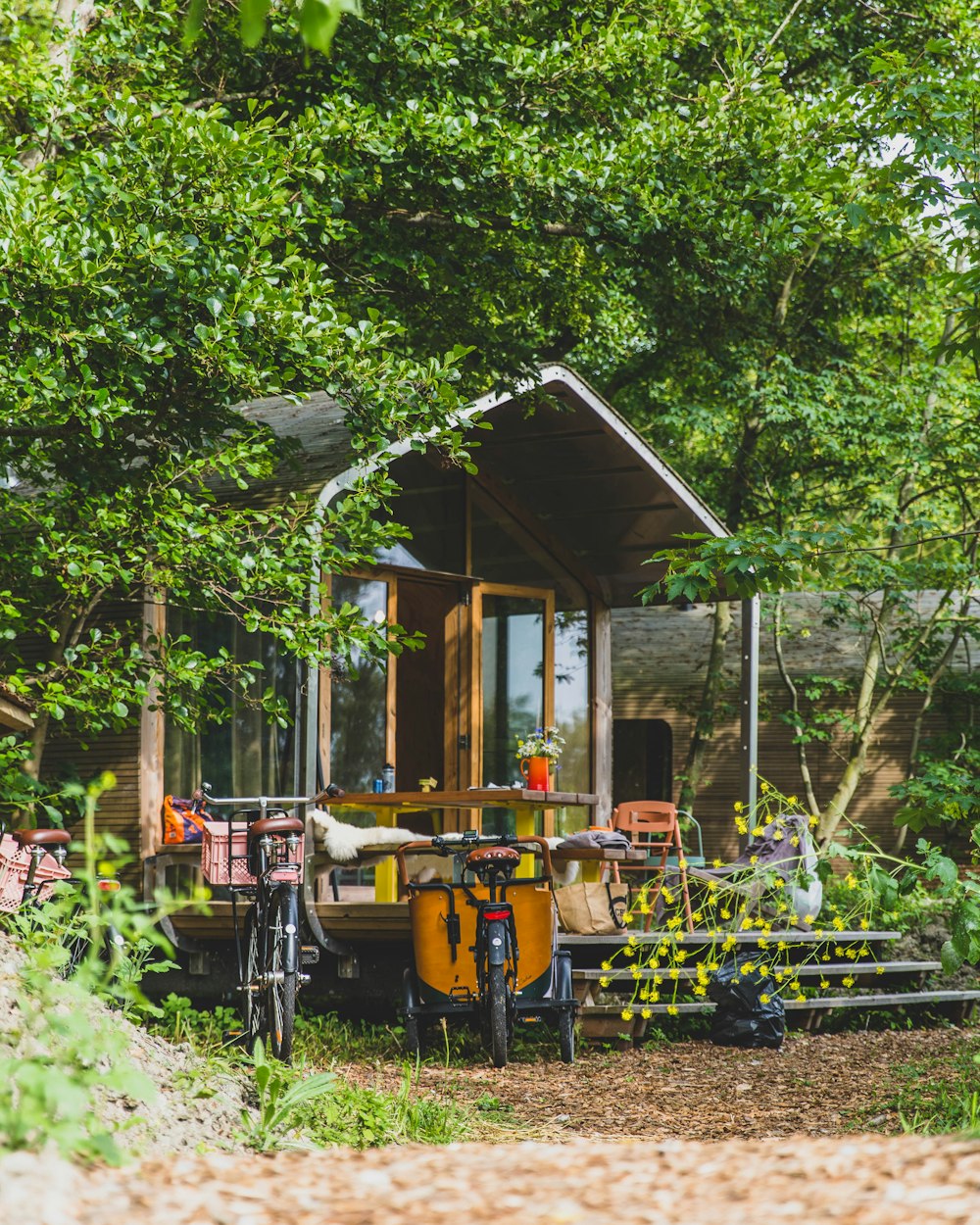 a bicycle parked in front of a small cabin