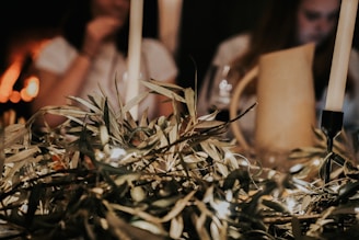 Guests enjoying a cozy night with olive green accents and golden candlelight at the restaurant.