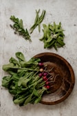 Fresh vegetables arranged on a rustic wooden table.