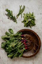 Close-up of fresh farm produce arranged artfully on a crisp parchment background.