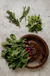 An artful arrangement of exotic imported vegetables displayed on a rustic wooden table.