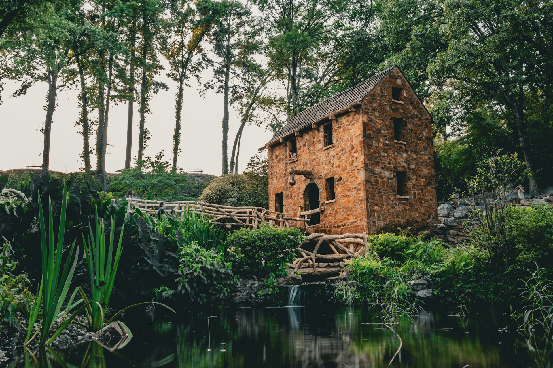 a small house sitting on top of a lush green forest