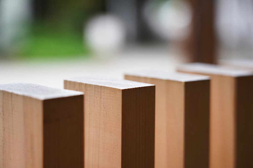 a close up of a wooden fence with a blurry background