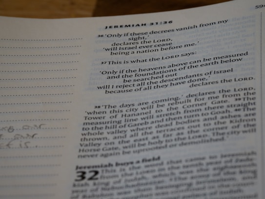 A close-up view of a page from the Bible, specifically featuring text from the book of Jeremiah, chapter 31. Verses 36 to 38 are highlighted with additional detail. There are marginal notes and some handwritten notes on the left side.