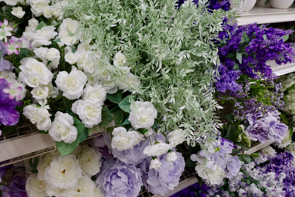 a bunch of flowers that are on a shelf