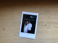 Polaroid-style photo of a smiling partner shaking hands in a cozy office setting