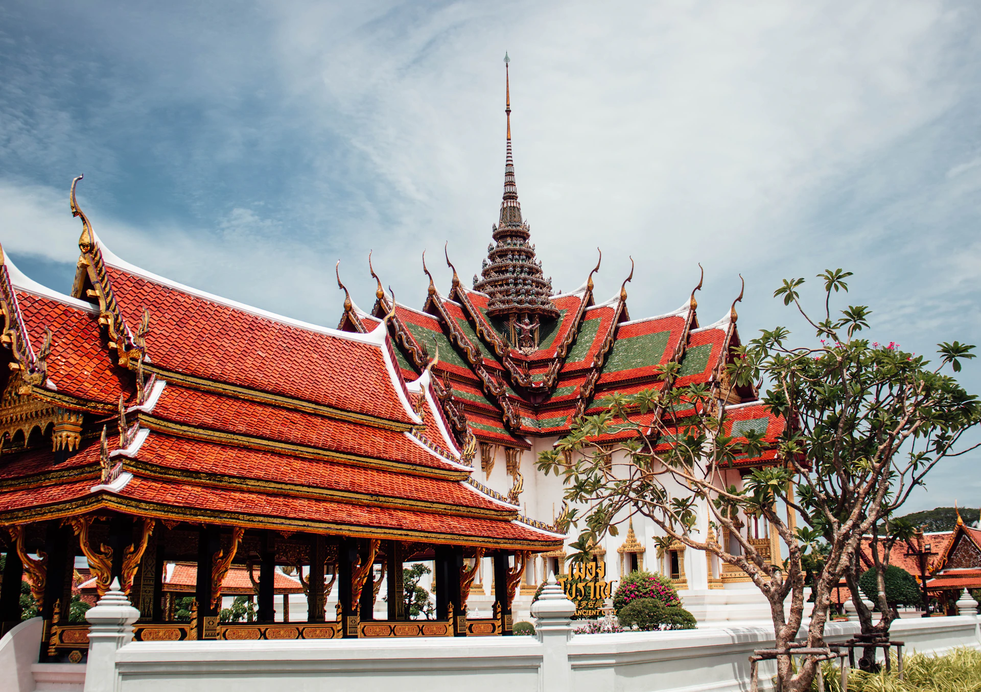 a building with a red roof and a white fence