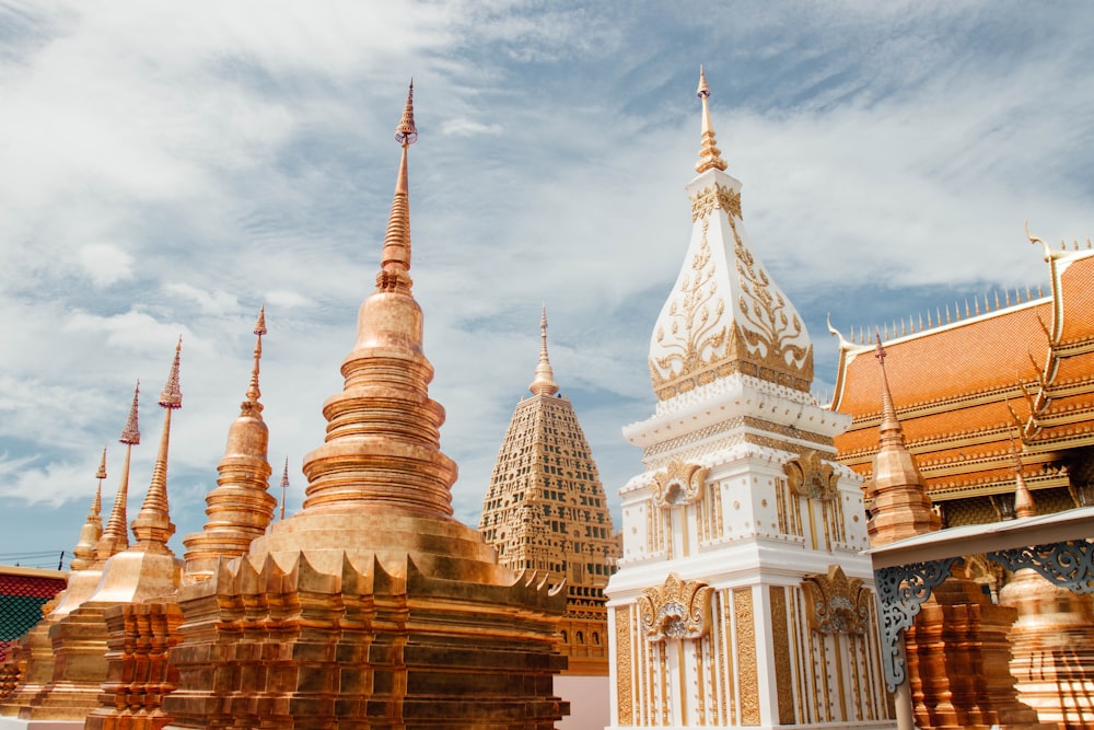 a group of gold and white buildings under a blue sky