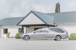 a silver car parked in front of a house