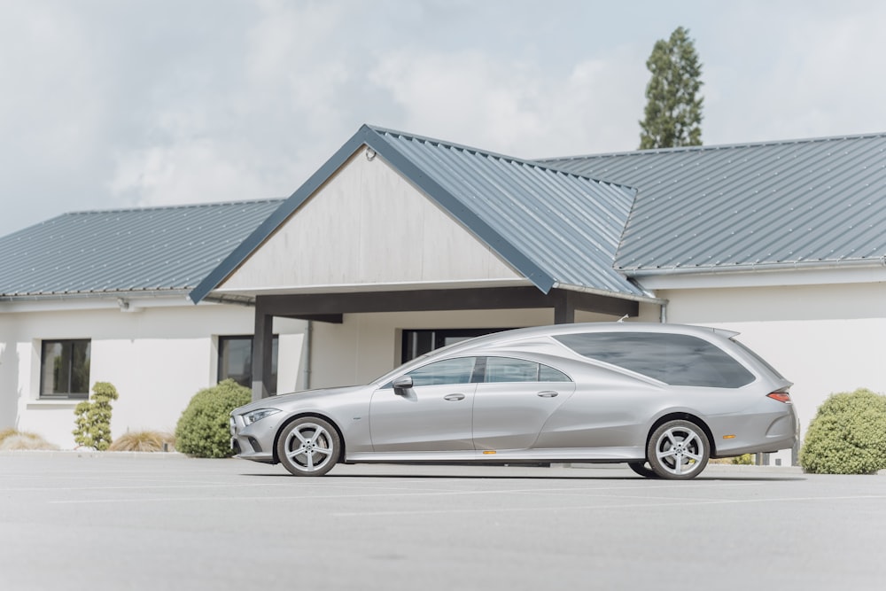 a silver car parked in front of a house