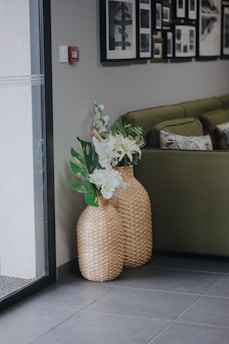 Bright living room with elwoodvalley’s canvas prints and natural woven baskets styled on a wall.