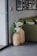 A happy customer using Invesco baskets in her living room.