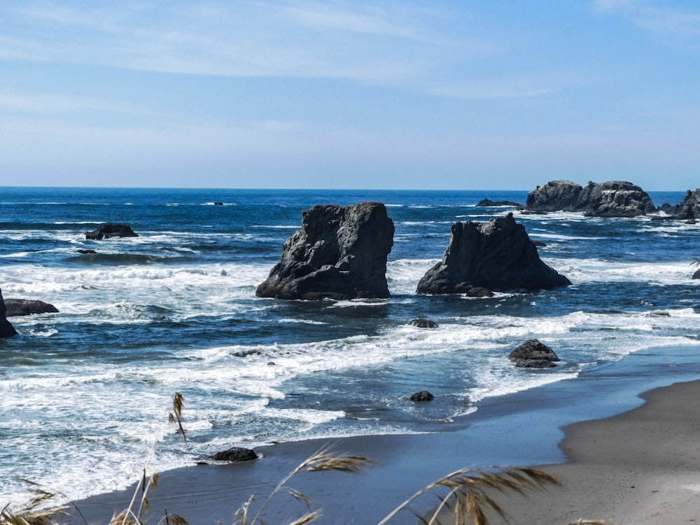 a view of the ocean with rocks in the water