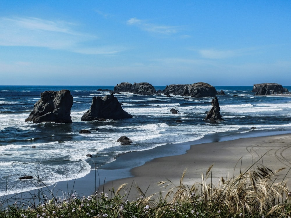 a view of a beach with rocks in the water