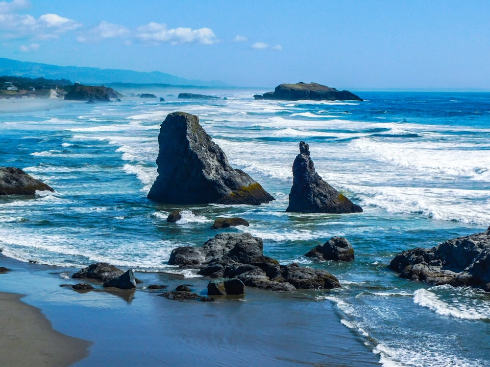 a view of the ocean with rocks in the foreground