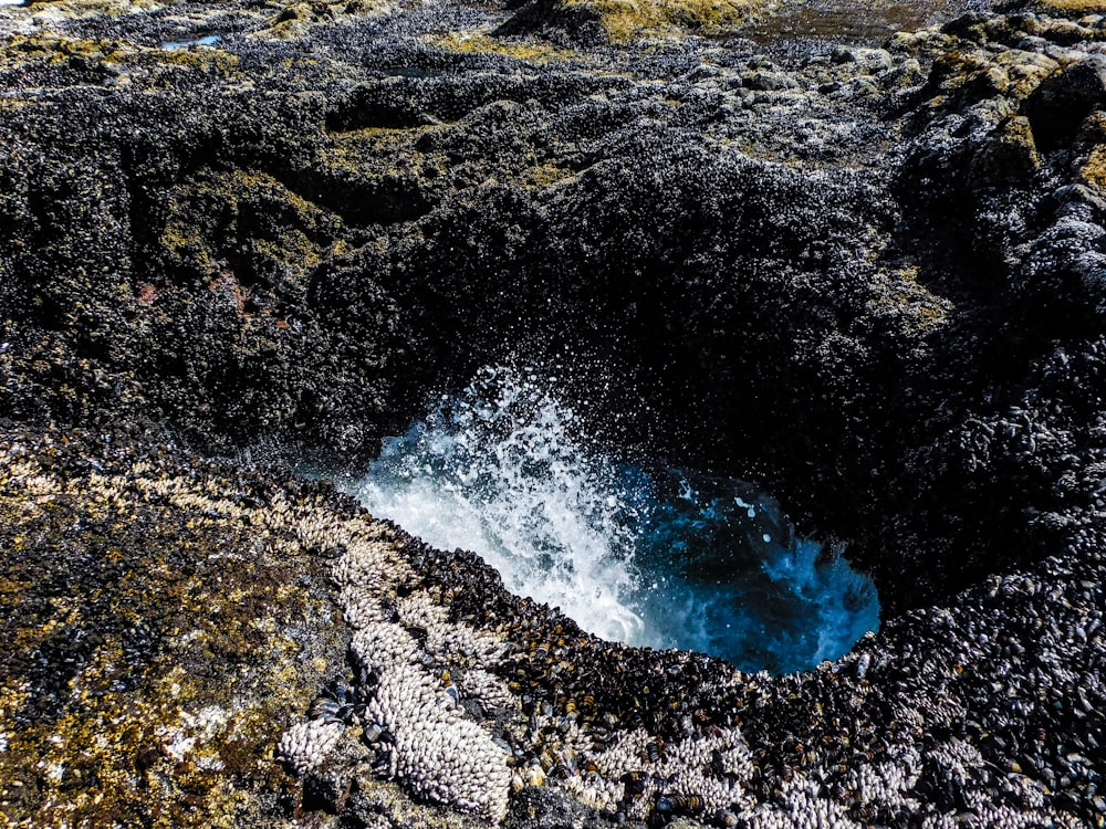 a hole in the ground with water coming out of it