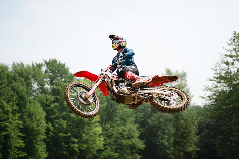 a man riding a dirt bike through the air