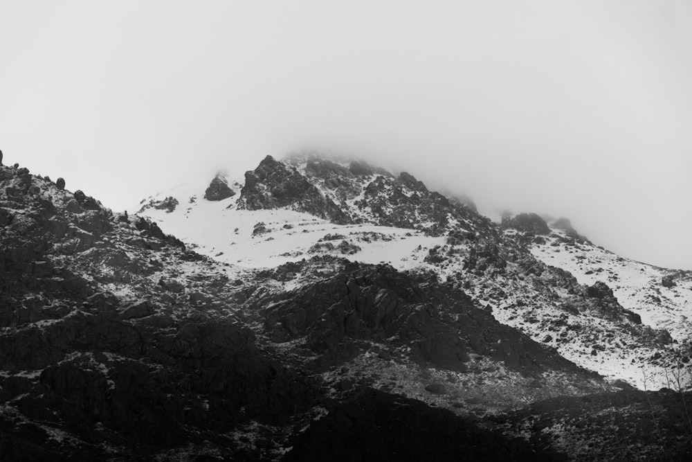 a black and white photo of a snow covered mountain