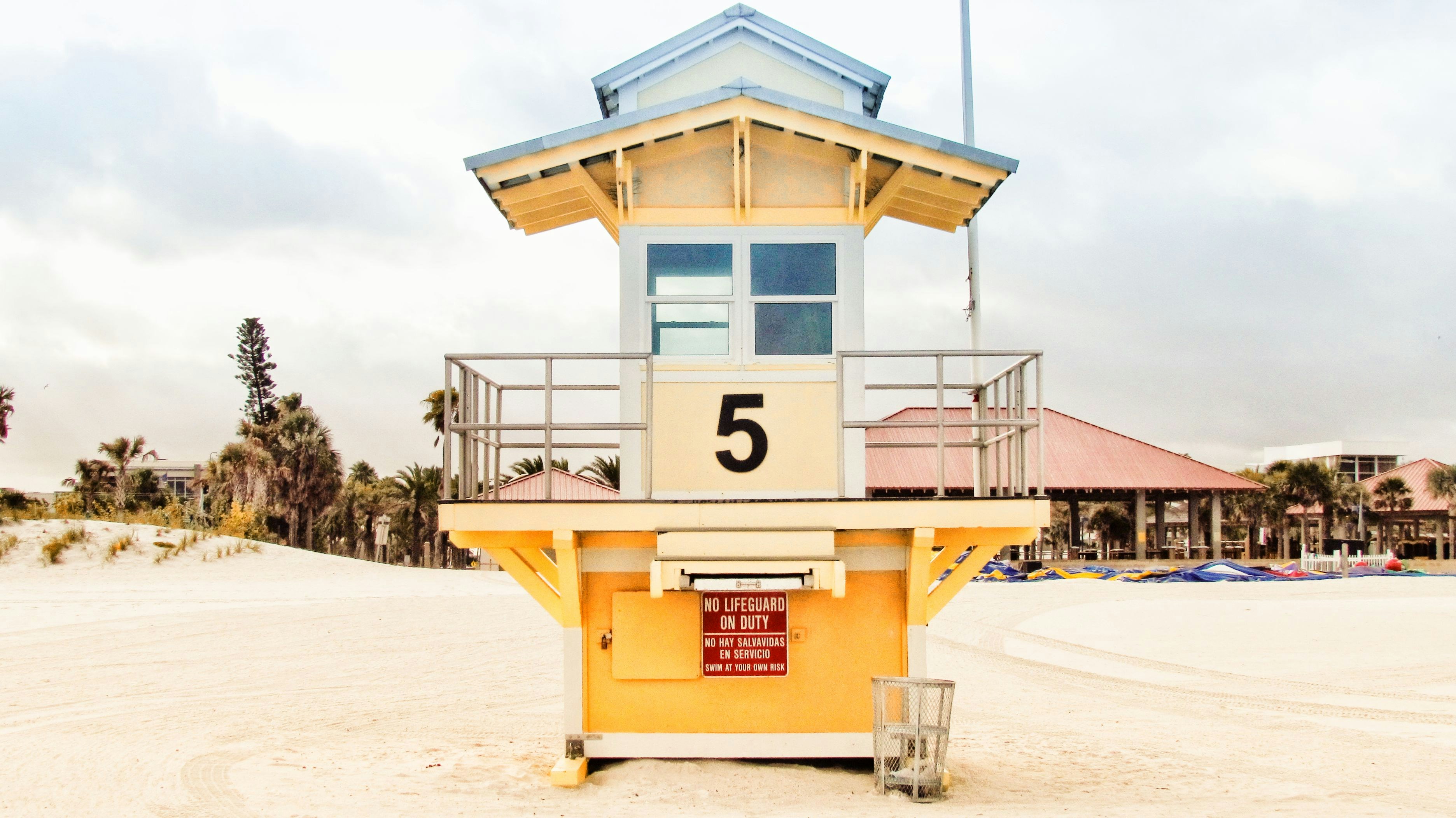 a lifeguard tower sitting on top of a sandy beach