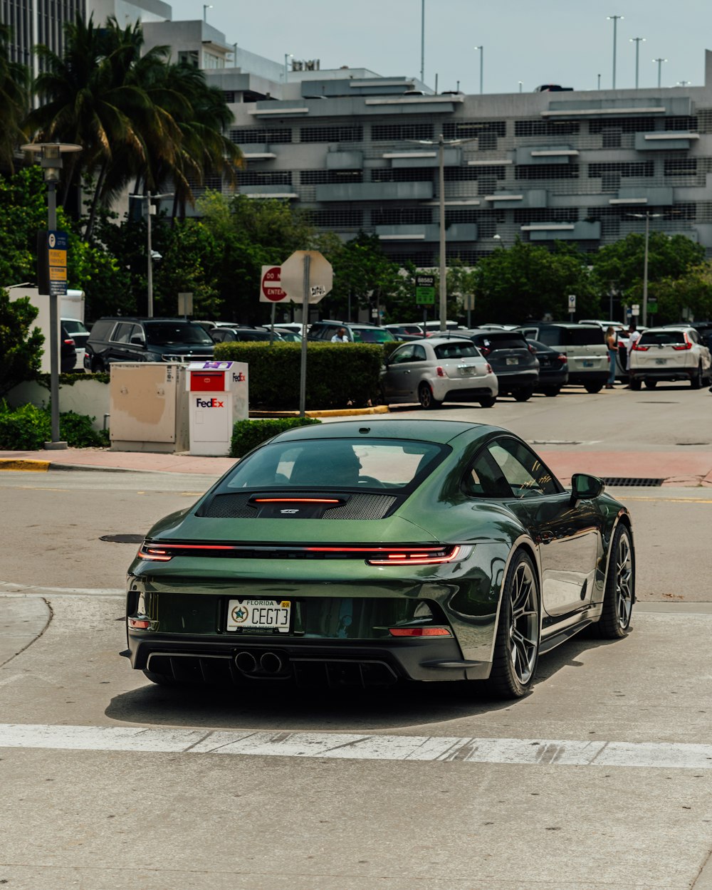 a green sports car parked in a parking lot