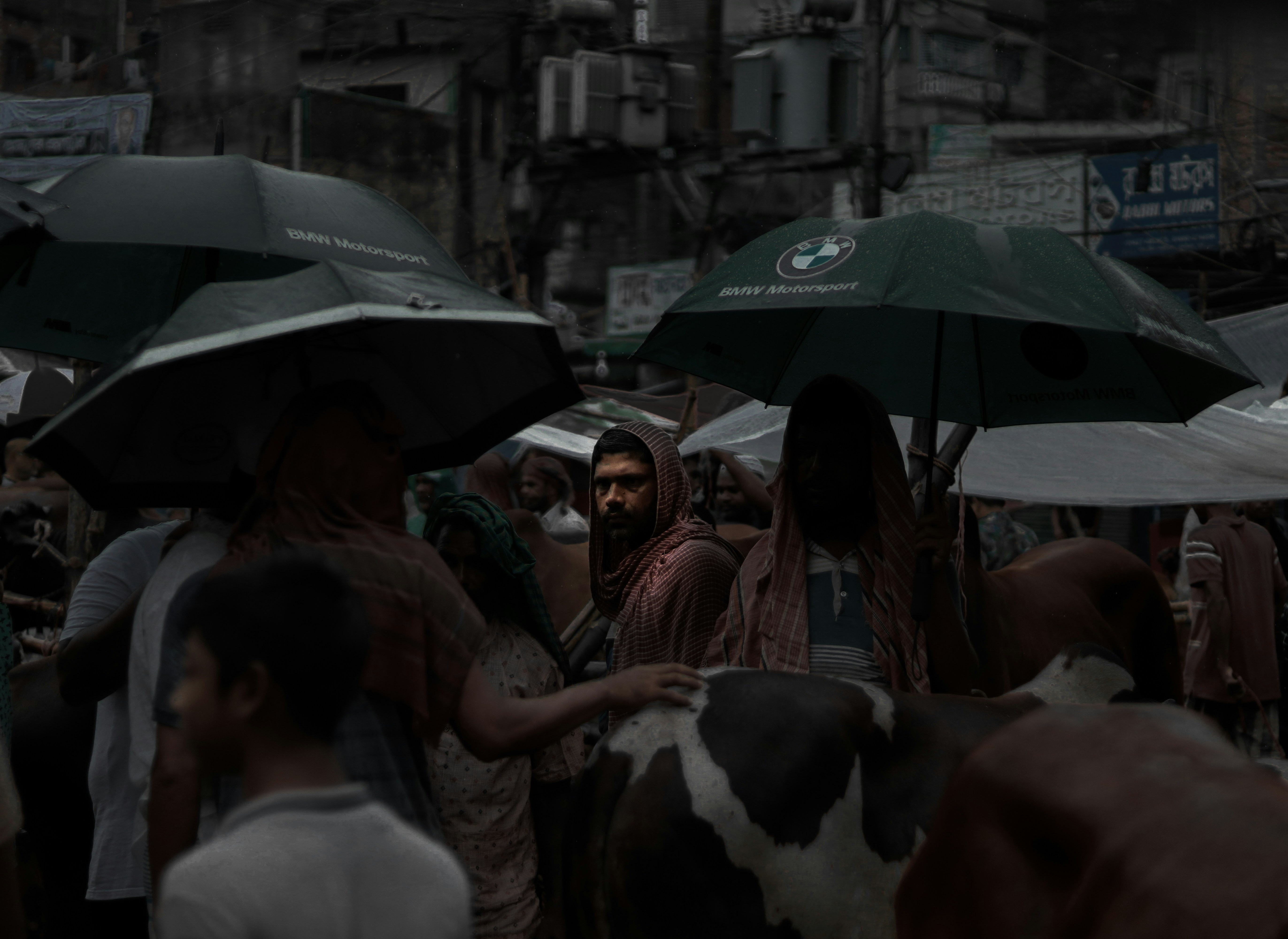 Group of people with umbrellas illustrating the monsoon climate in Dhaka