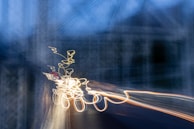 Abstract light trails captured during a techno music event.