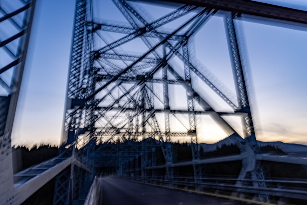 a reflection of a bridge in a window