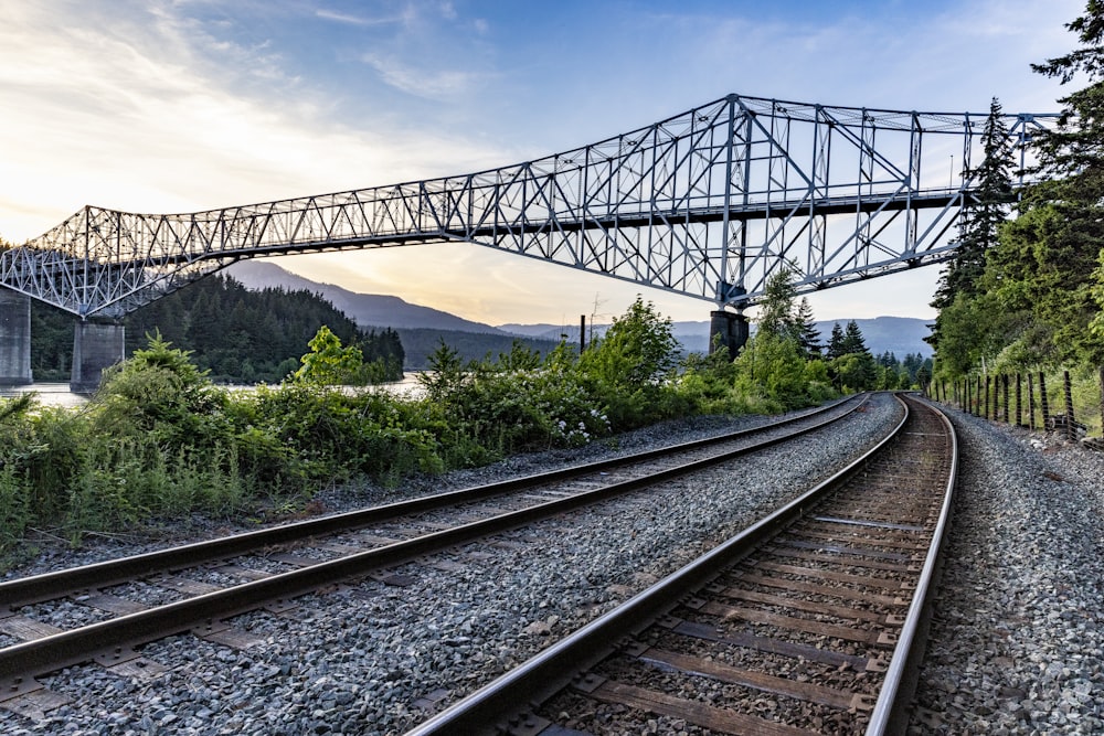 a train track with a bridge in the background