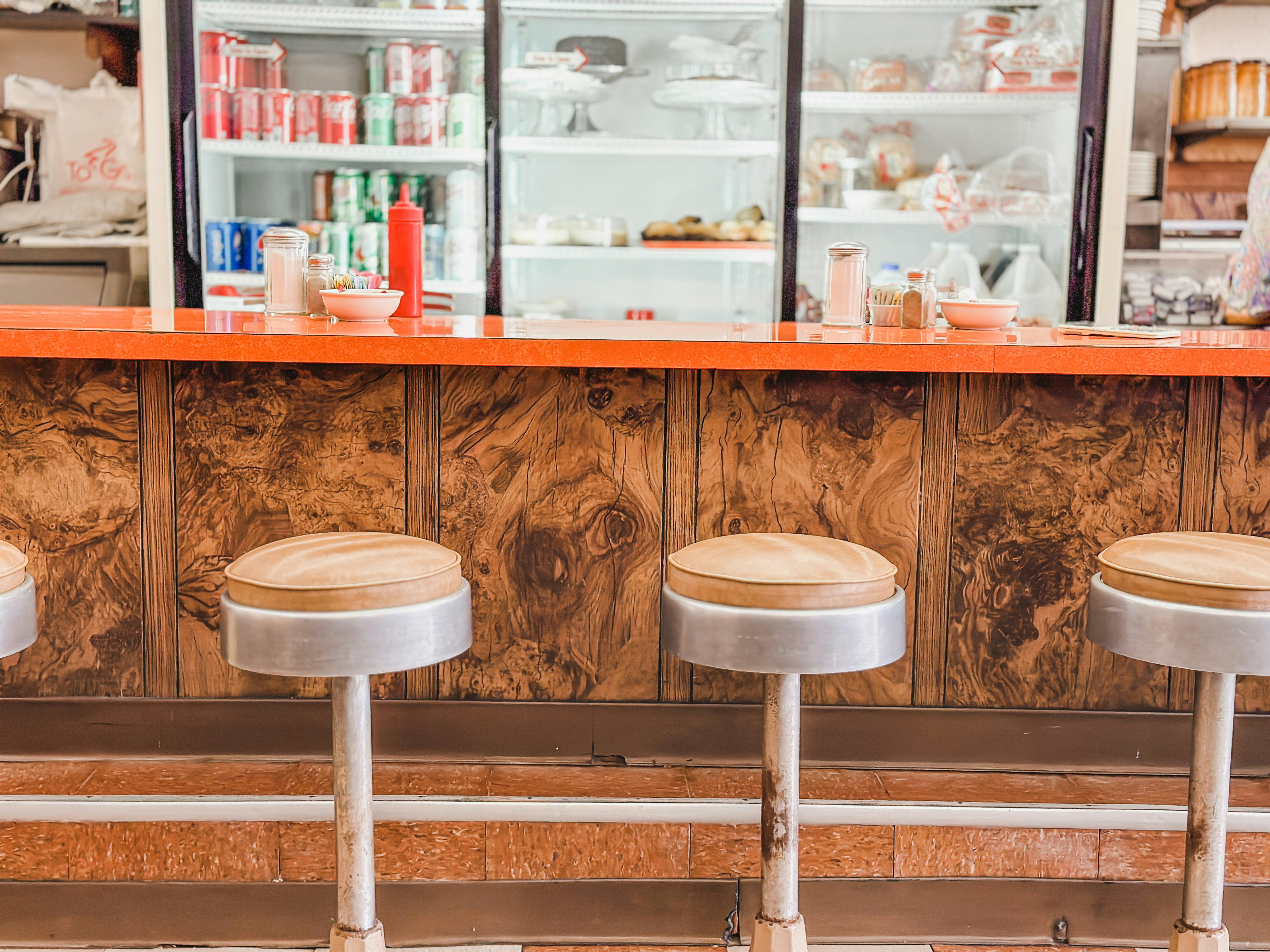 three stools sitting in front of a counter
