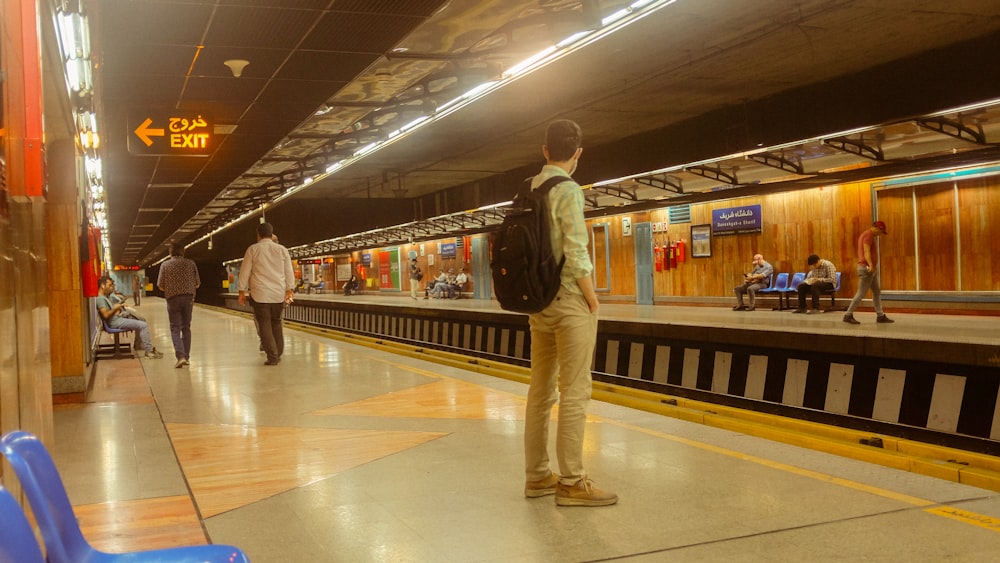 a group of people standing on a train platform