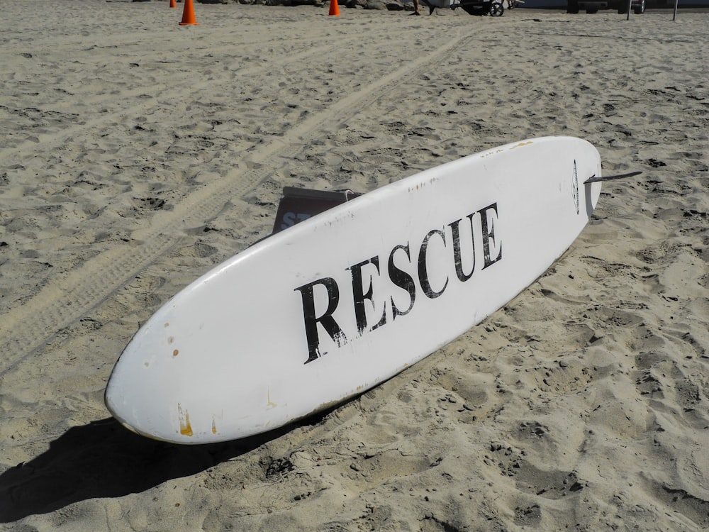 a surfboard that is laying in the sand