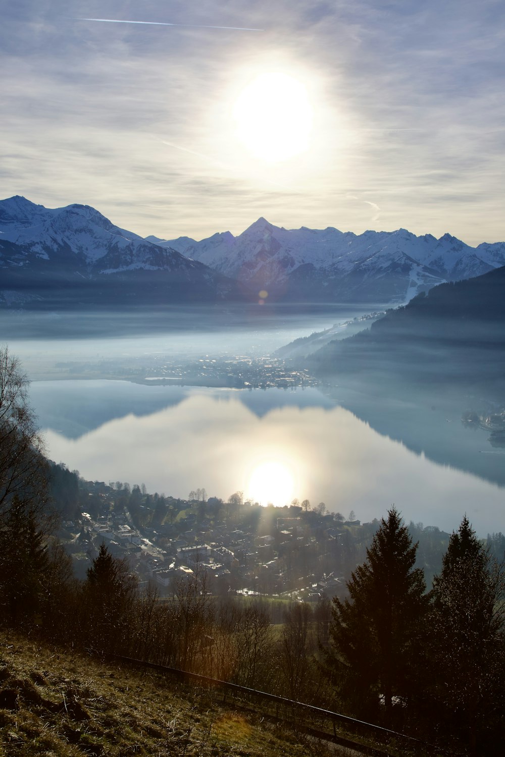 the sun is shining over the mountains and a lake